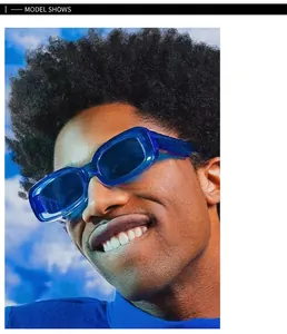 Blue translucent rectangular sunglasses worn by model against blue sky backdrop