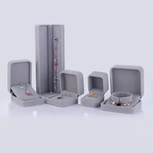 Gray velvet jewelry box collection including necklace, bracelet, and ring gift packaging