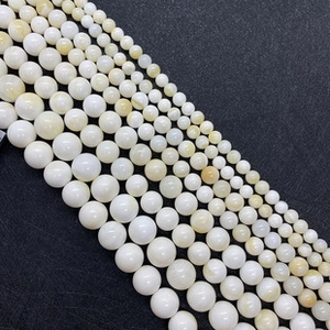 Macro detail of natural freshwater shell star beads in cream white and orange tones