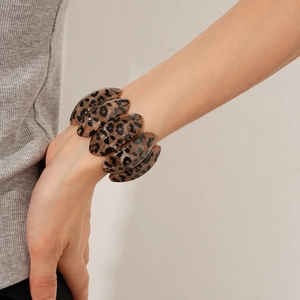 Close-up of vintage leopard print resin bracelet on wrist with oval link design