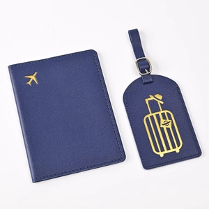 Detailed close-up of blue PU leather passport holder and luggage tag with gold embroidery