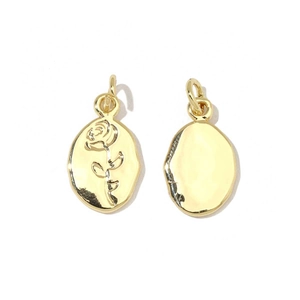 Detailed view of gold oval rose charm and polished blank pendant with top jump rings