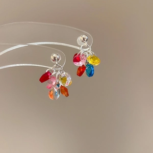 Detailed close-up of colorful acrylic flower stud earrings with vibrant mixed beads