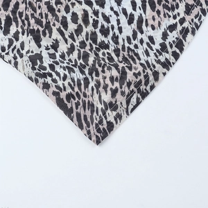 Macro shot of leopard print fabric showing fine stitching and mesh texture details