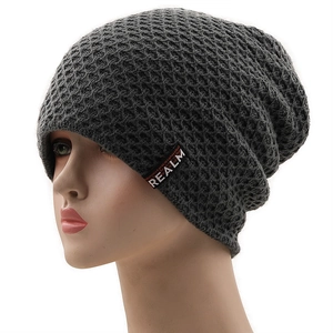 Detailed honeycomb weave texture and REALM label on dark grey men's winter beanie