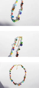 Detail view of colorful floral glass beads and pearls on a bohemian style necklace