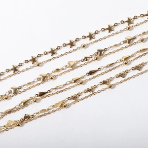Detail of double-layer stainless steel bracelets with star, heart and butterfly charms