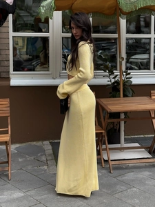 Macro detail of the soft ribbed knit texture on the yellow maxi skirt and long sleeve top set