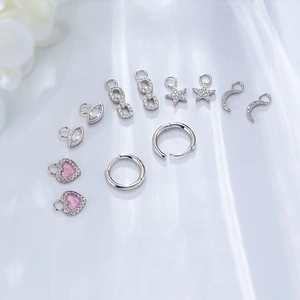 925 Sterling silver earring set with star, heart, and moon pendants on blue silk