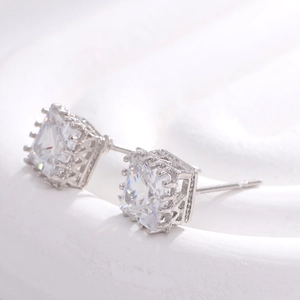 Macro shot of silver geometric square-cut stud earrings with sparkling cubic zirconia