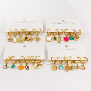 Golden stainless steel hoop earrings set with enamel charms and natural stone dangles
