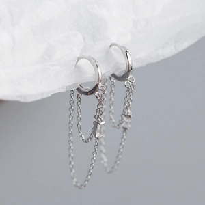 Close-up of s925 silver hoop earrings featuring double chain tassels and square crystals