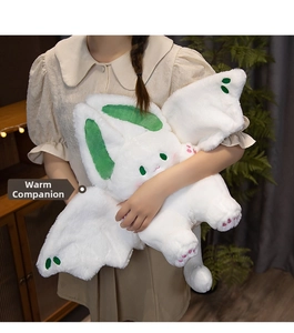 Close-up of soft plush bat rabbit doll with green ears and pink paw embroidery