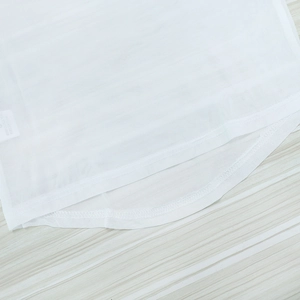 Detail shot of white mesh fabric showing fine stitching and double-edged seam quality