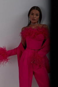 Detailed view of ostrich feather trim on the cuffs of a magenta pink blazer set