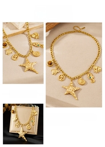 Detailed macro of gold plated starfish and seahorse pendants on a heavy chunky link chain