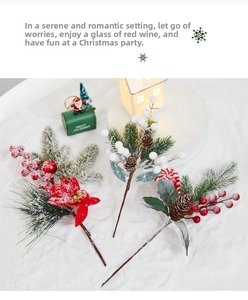 Detail of faux pine branches with red berries and pinecones under artificial snow