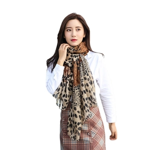 Elegant oversized leopard print silk scarf for women in soft brown tones, professional model view