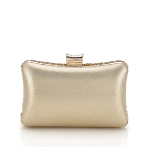 Detailed macro view of a gold evening clutch with sparkling rhinestone top embellishment