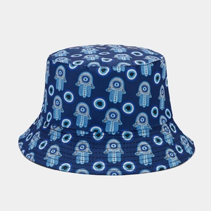 Detail of navy blue bucket hat featuring embroidered Hamsa and Evil Eye symbols