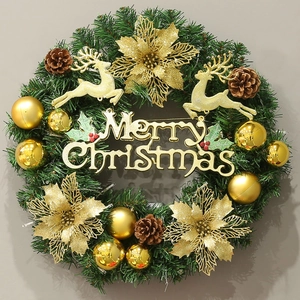 Detail of Christmas wreath with golden poinsettias, reindeer decors and Merry Christmas sign