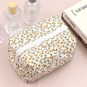 Floral makeup bag detail with yellow flowers, sturdy cotton fabric, and white zipper closure