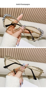 Detail of gold metal cat-eye sunglasses with rhinestone studs and champagne lenses