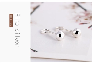 Detail of S990 fine silver bead stud earrings with polished finish and material engraving
