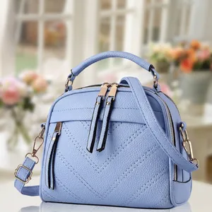Light blue lychee texture crossbody bag with V-stitch design and double zipper