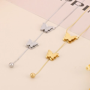 Detail of gold and silver butterfly pendant necklaces with matte and polished finish