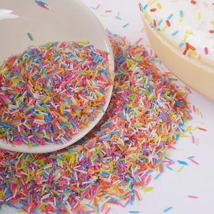Mix of colorful sprinkles pouring from a bowl for cake and donut decoration