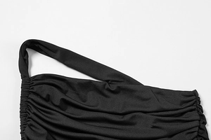 Detail view of the black ruched side seams and asymmetrical shoulder strap fabric