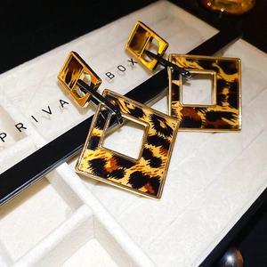 Detailed close-up of vintage leopard print square earrings with golden metal frames
