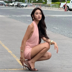 Detail of pink two-piece set featuring a halter top and ruched mini skirt in street style