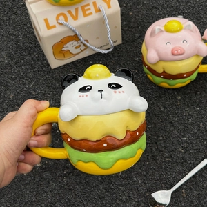 Close-up of creative panda and pig burger ceramic mugs with stacked hamburger layers