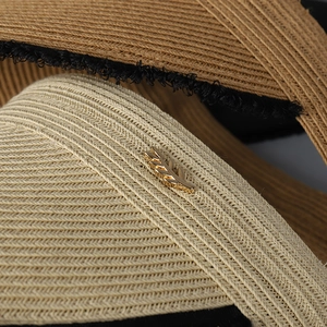 Foldable straw sun hat with golden leaf buckle and black fringe trim for women