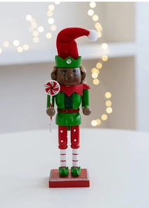 Macro detail of wooden nutcracker soldier holding a candy cane with Christmas bokeh background