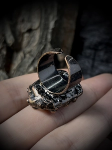 Detail of adjustable vintage ring with black oxidized texture and hammered bronze finish