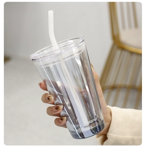 Detail shot of transparent glass straw cup featuring Gorgeous print and white silicone straw