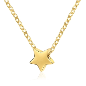 Macro detail of high-polished 18K gold star pendant on a minimalist link chain