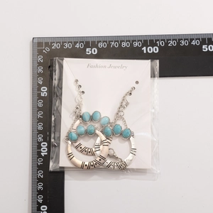 Detailed view of turquoise coconut tree necklace set with ruler for size measurement