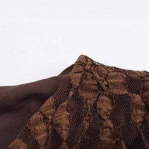 Detailed texture of dark brown lace maxi dress with floral patterns and sheer mesh fabric