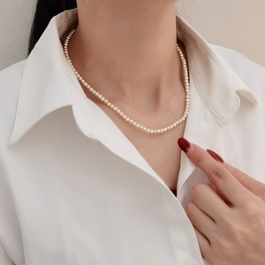 Elegant natural freshwater pearl necklace on a model wearing a white shirt