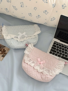Detailed close-up of quilted pink and blue lace crossbody bags with ribbon bow details