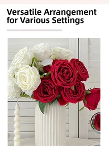 Artificial red and white roses in a white ceramic vase for home interior decoration