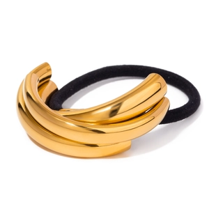 Detail of golden triple-tube metallic ornament on high-elasticity black hair tie
