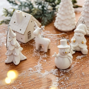 Mini ceramic Christmas house figurines featuring Santa and Reindeer in pearl white and gold