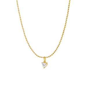 Macro view of dainty golden heart pendant with clear sparkling zircon on bead chain