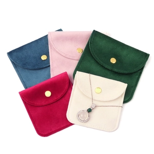 Minimalist velvet jewelry pouches with gold snap buttons in five elegant colors