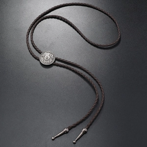 Retro American western bolo tie with brown braided leather rope and carved silver buckle